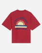 Back of red oversized t-shirt with sunset graphic and 'Lazy Chillin GOAT USA' text