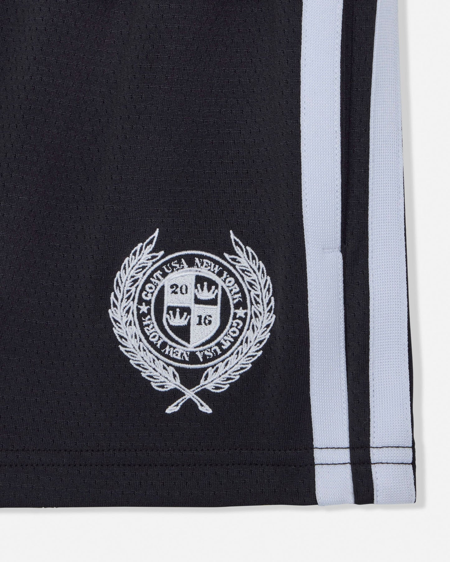 Black shorts with white emblem and stripe on a white background#color_black