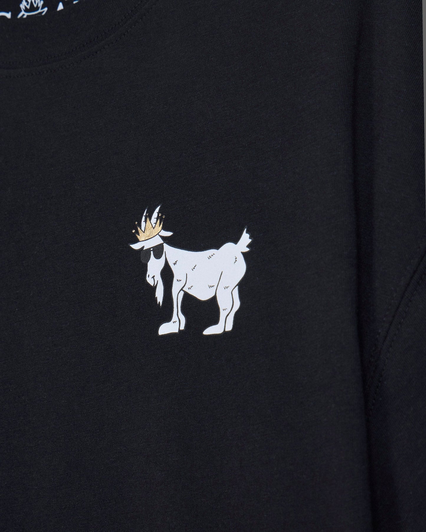 Close-up of black oversized crop top with white goat design#color_black