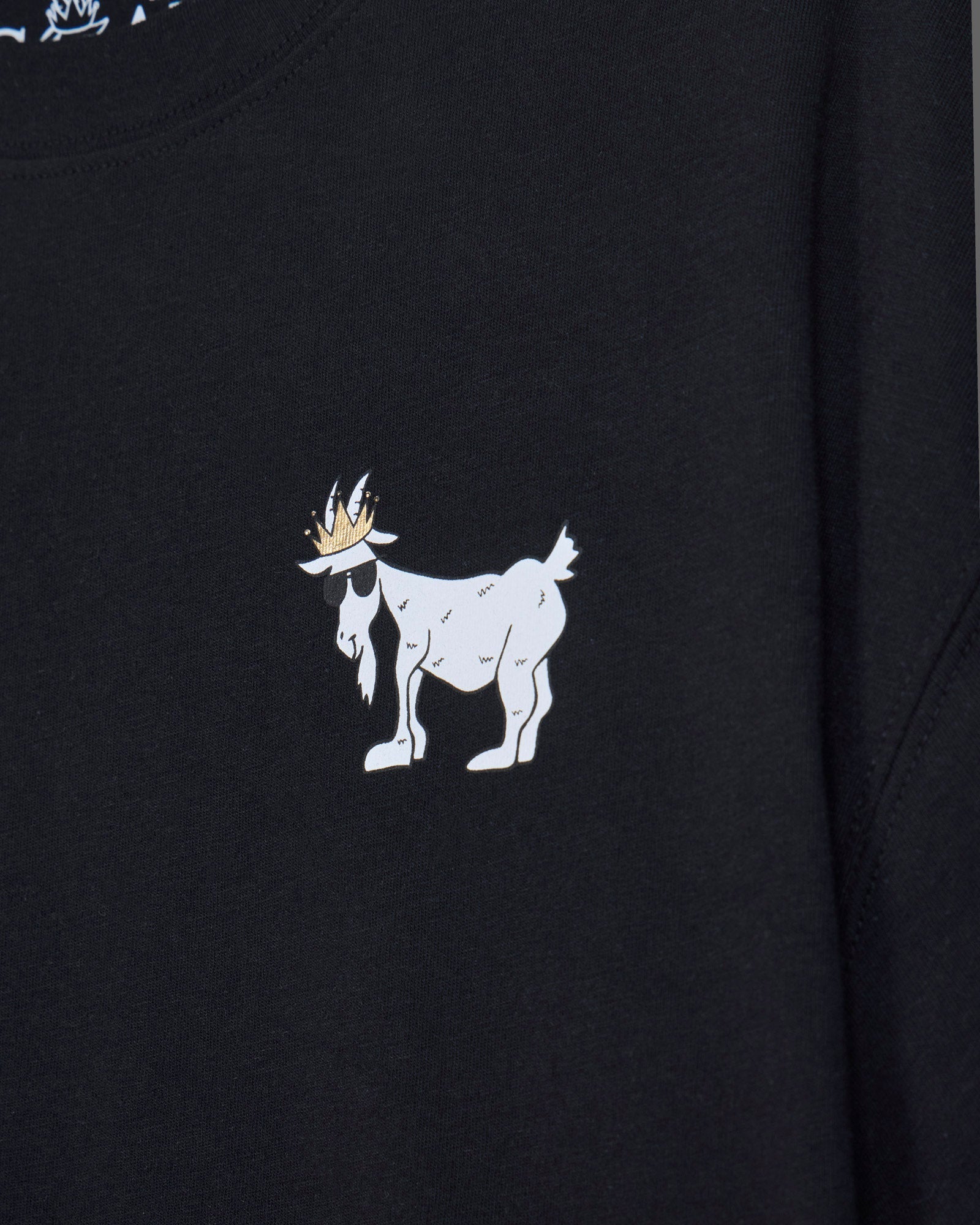 Close-up of black oversized crop top with white goat design#color_black