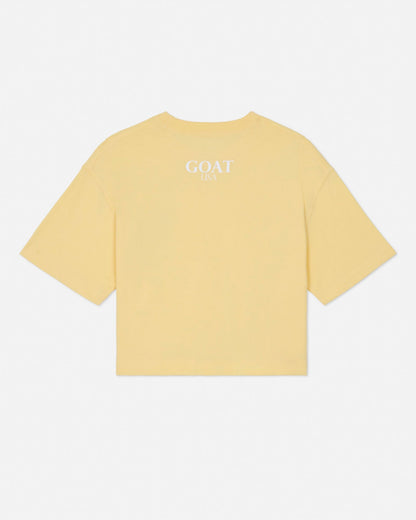 Yellow t-shirt with 'GOAT' text on the back against a white background#color_corn-milk