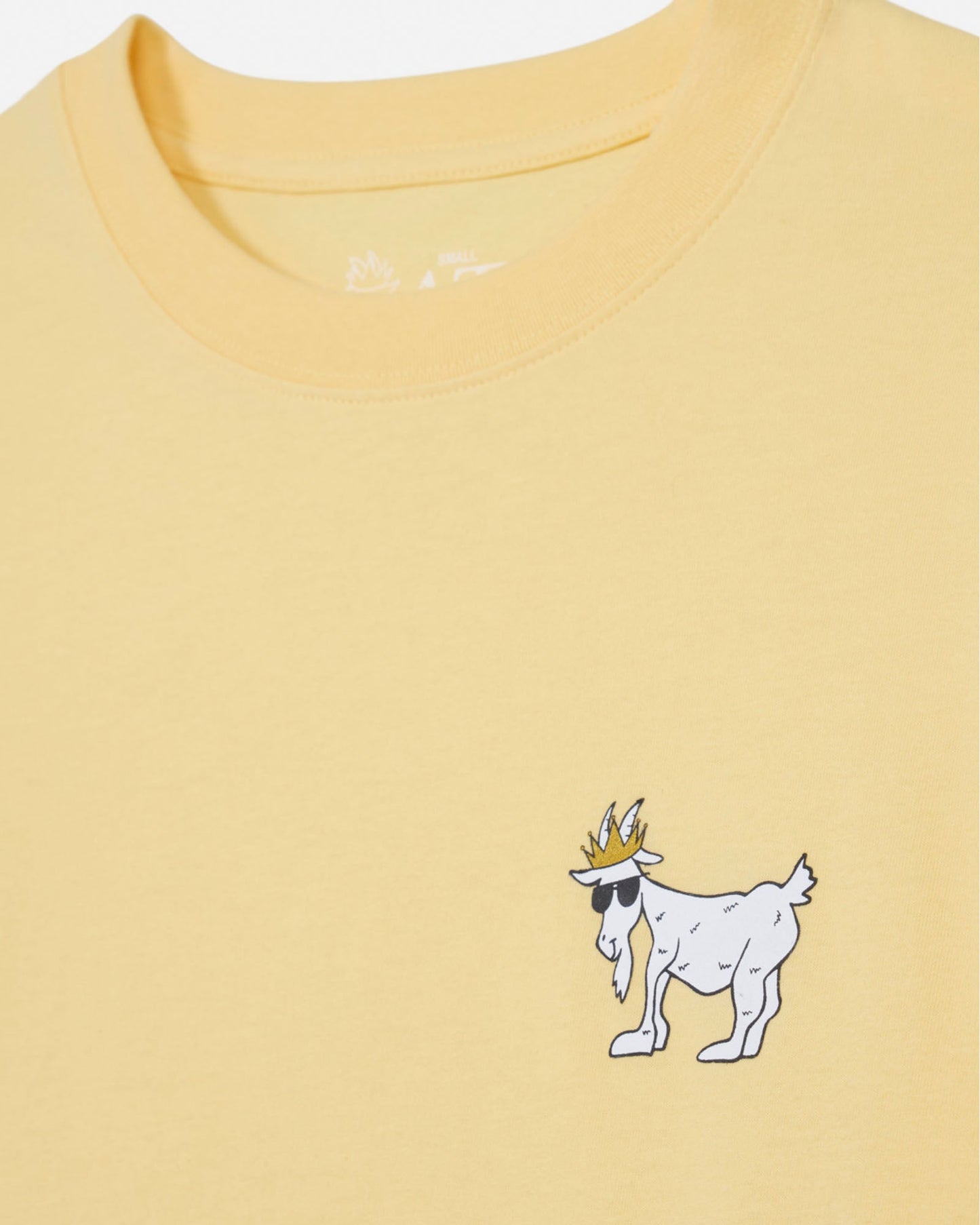 Yellow t-shirt with a cartoon goat wearing a crown on a white background#color_corn-milk