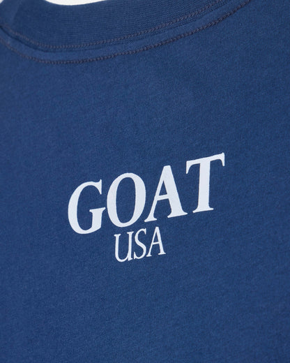Close up of back of blue oversized crop top with 'GOAT USA' text#color_moonlite-ocean