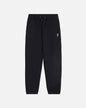 Black sweatpants with a small white logo on a light gray background#color_black