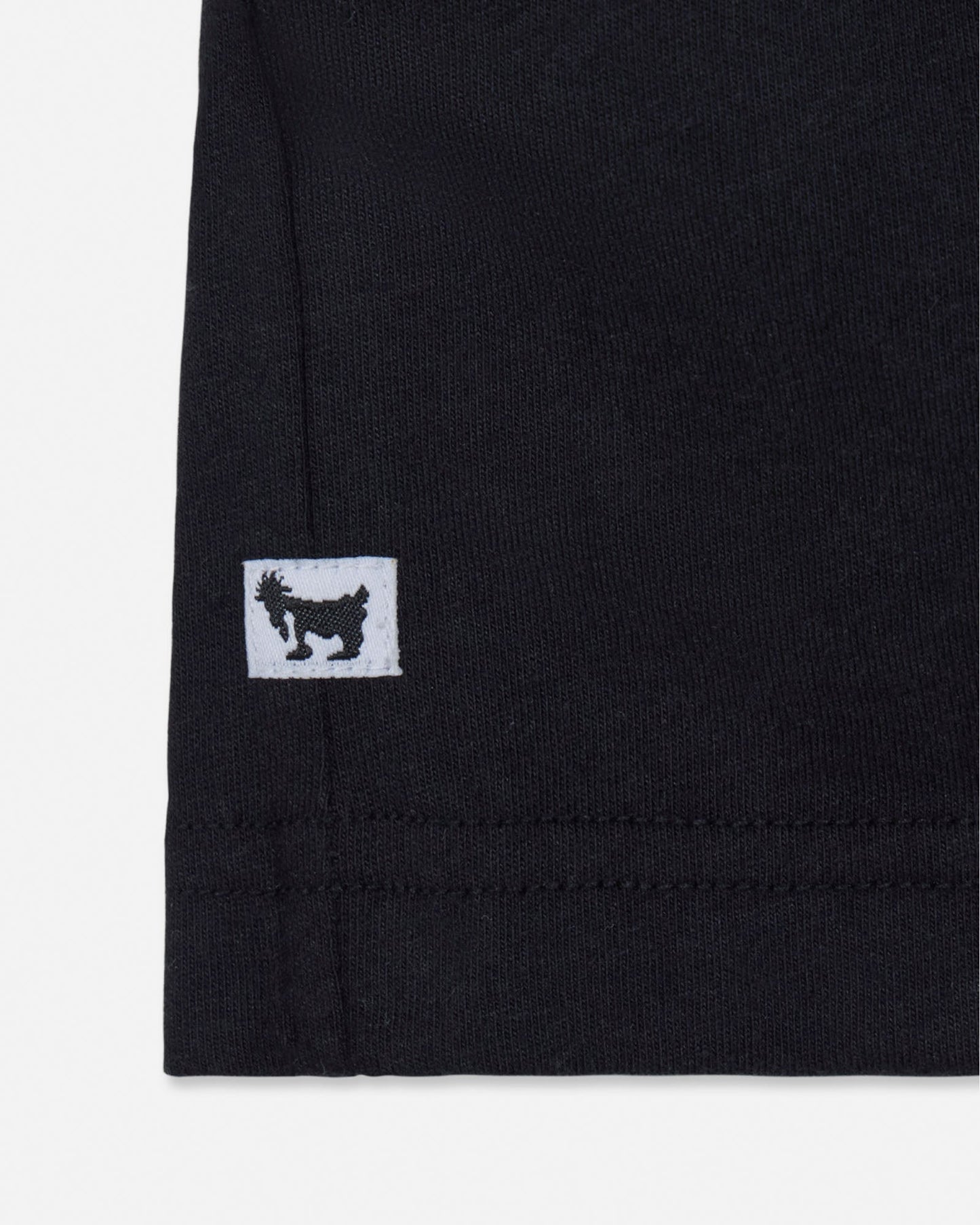 Black fabric with a small white logo featuring a black silhouette on a white background#color_black