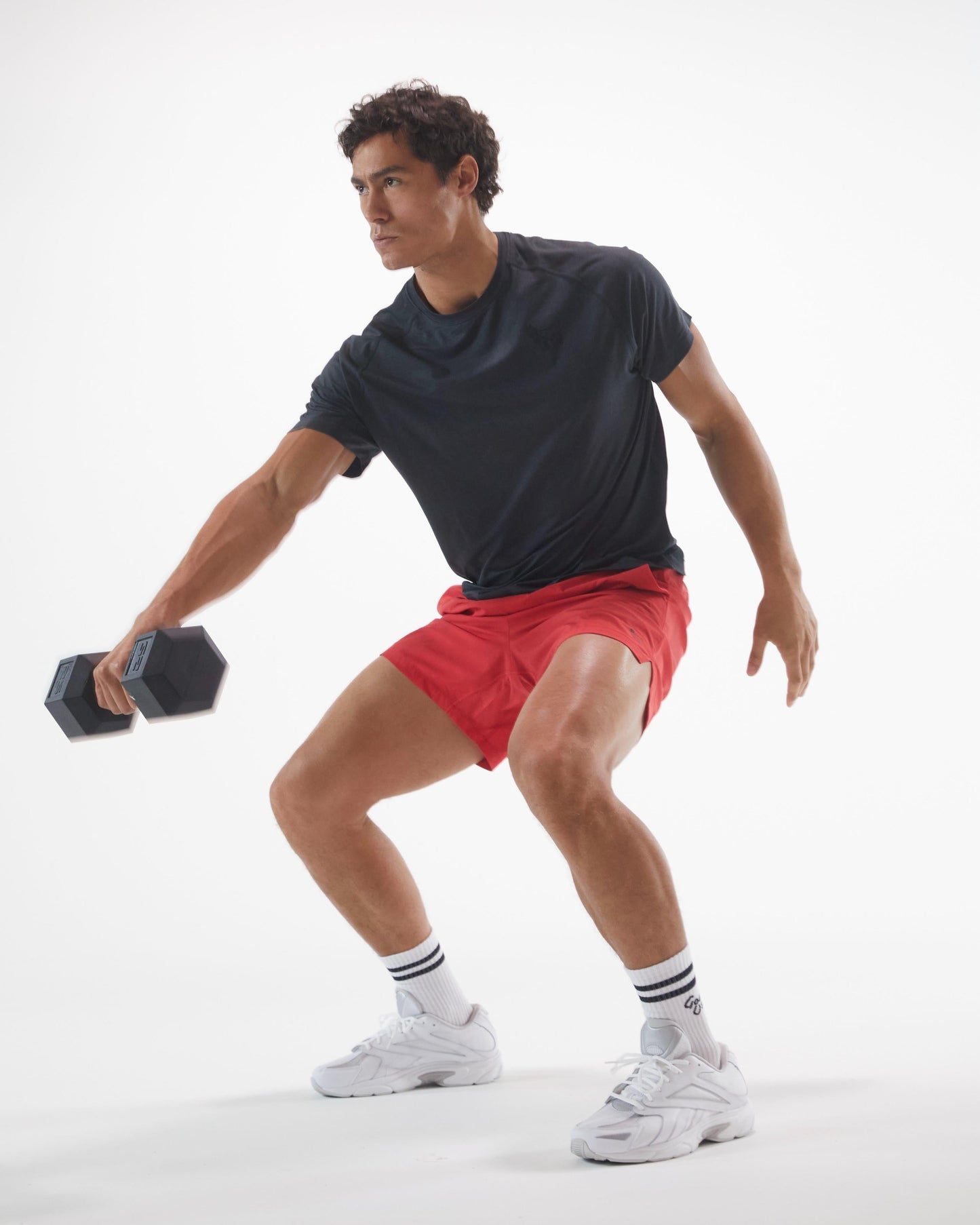 Man exercising with dumbbells on a white background#color_black