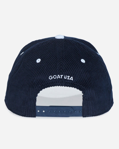 The back of a dark navy blue corduroy baseball cap featuring 'GOAT USA' embroidered in white on the front, with a white snapback closure at the bottom.