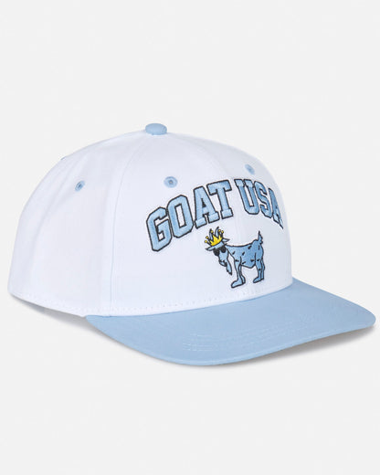 Angled view of white flat brim with "GOAT USA" text and Chuck the GOAT logo