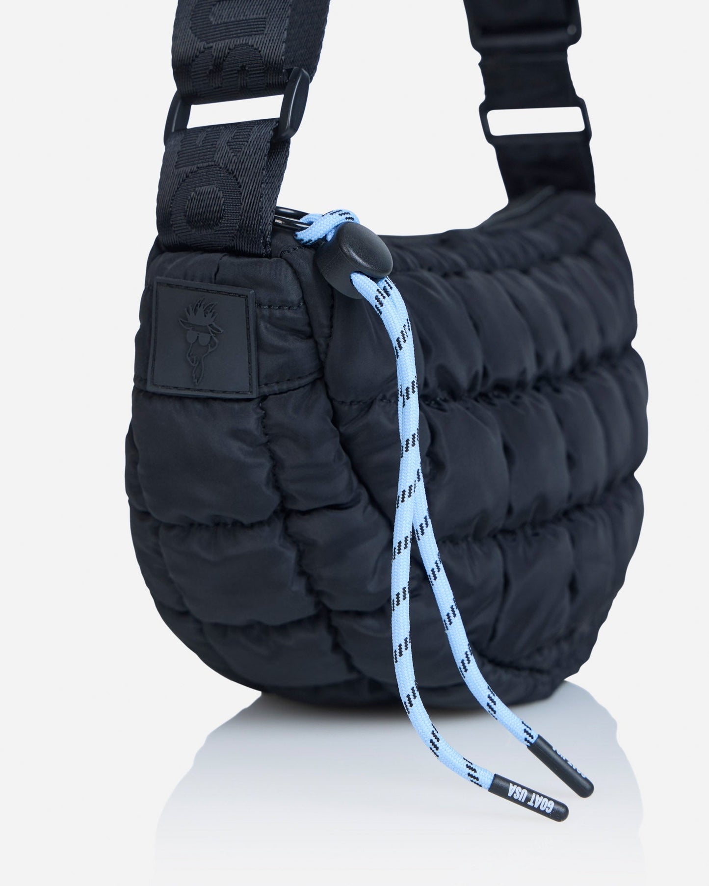 Close-up of strings on black sling bag