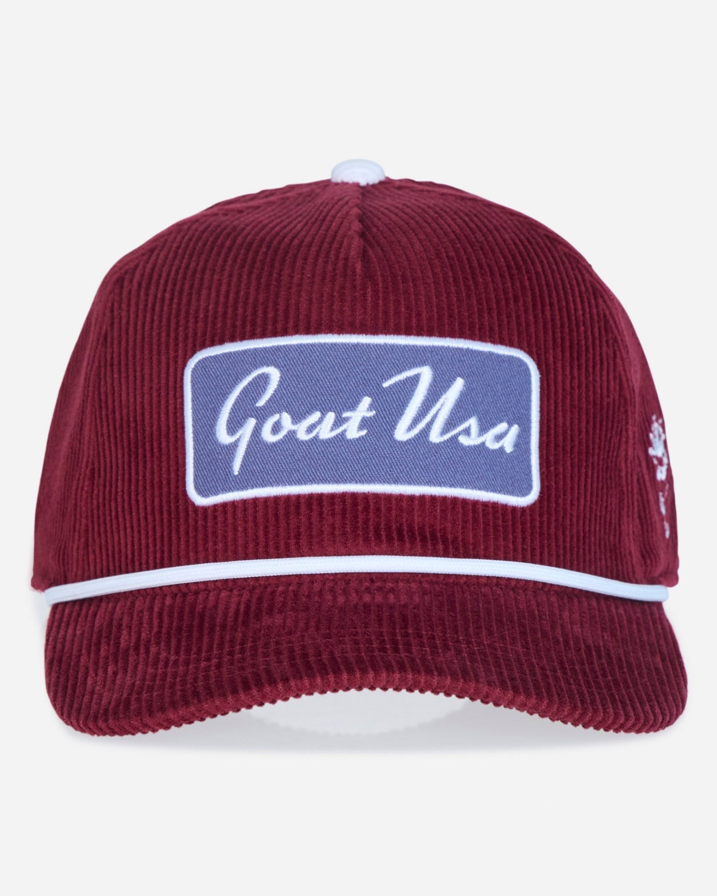 A burgundy corduroy baseball cap with a white embroidered 'Goat USA' patch on the front, a white stripe across the brim, and a small embroidered logo on the side, shown against a light gray background.
