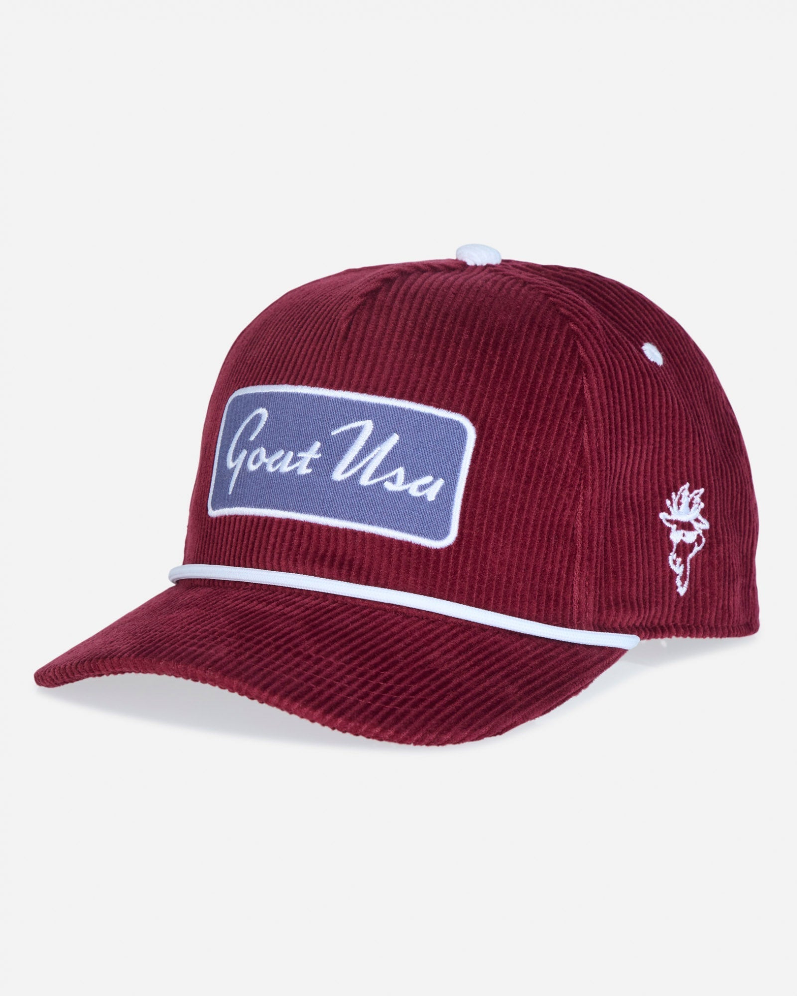 A burgundy corduroy baseball cap with a blue and white 'Goat USA' patch on the front, a white embroidered goat logo on the side, and a white piping accent along the brim, shown against a light gray background.