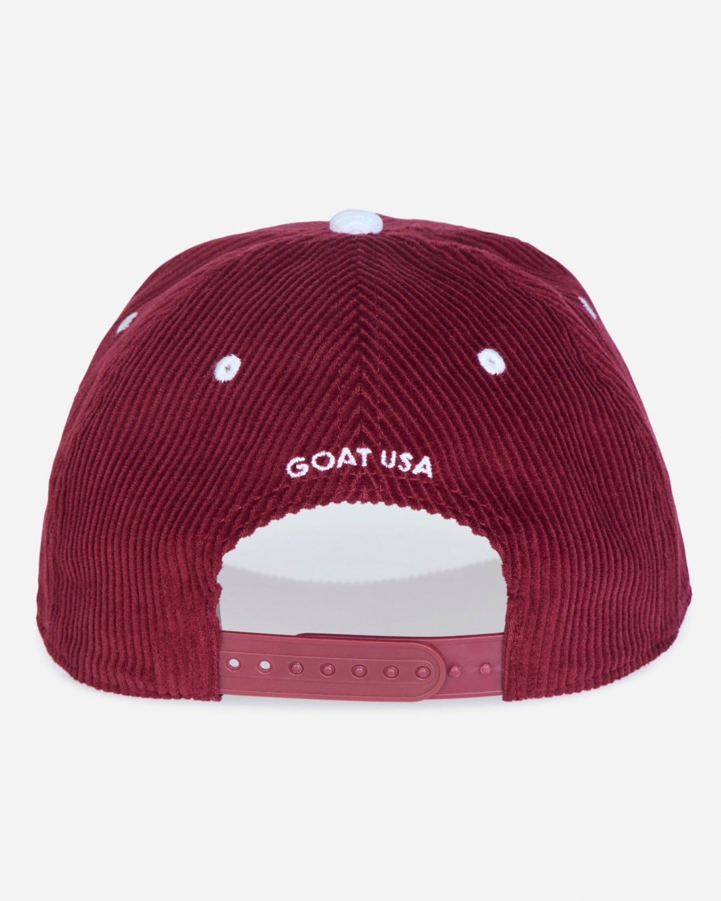 The back of a burgundy corduroy baseball cap featuring 'GOAT USA' embroidered in white on the crown, with a matching burgundy snapback closure and white ventilation eyelets.