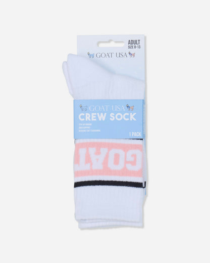 A pair of white crew socks in retail packaging from Goat USA. The socks feature a light pink horizontal band with the word 'GOAT' in white, and a thin black stripe above the band.#color_pink