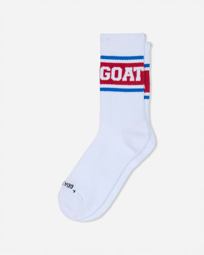 A single white crew sock with a red and blue stripe design and the word 'GOAT' in white on the cuff, shown on a light gray background.#color_true-red