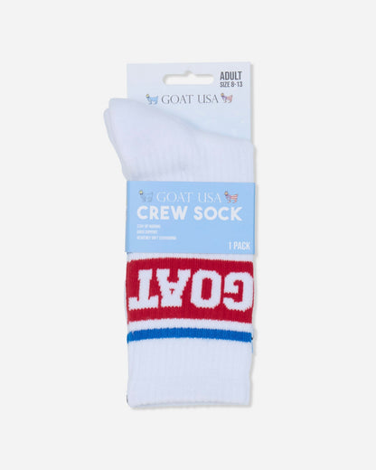 A pair of white crew socks with a red and blue stripe design and the word 'GOAT' in white on the red band, packaged on a light blue and white cardboard header card labeled 'GOAT USA CREW SOCK'.#color_true-red