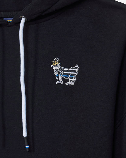 Close-up of a black hoodie featuring a white drawstring and a small embroidered goat mascot logo on the left chest, with blue and gold details.