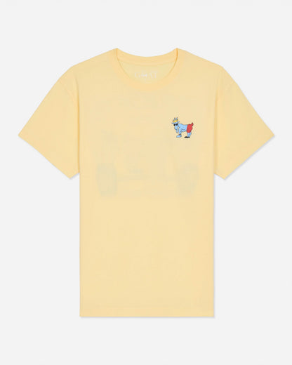 A pale yellow short-sleeve crewneck t-shirt with a small embroidered cartoon goat graphic on the left chest, displayed against a light gray background.