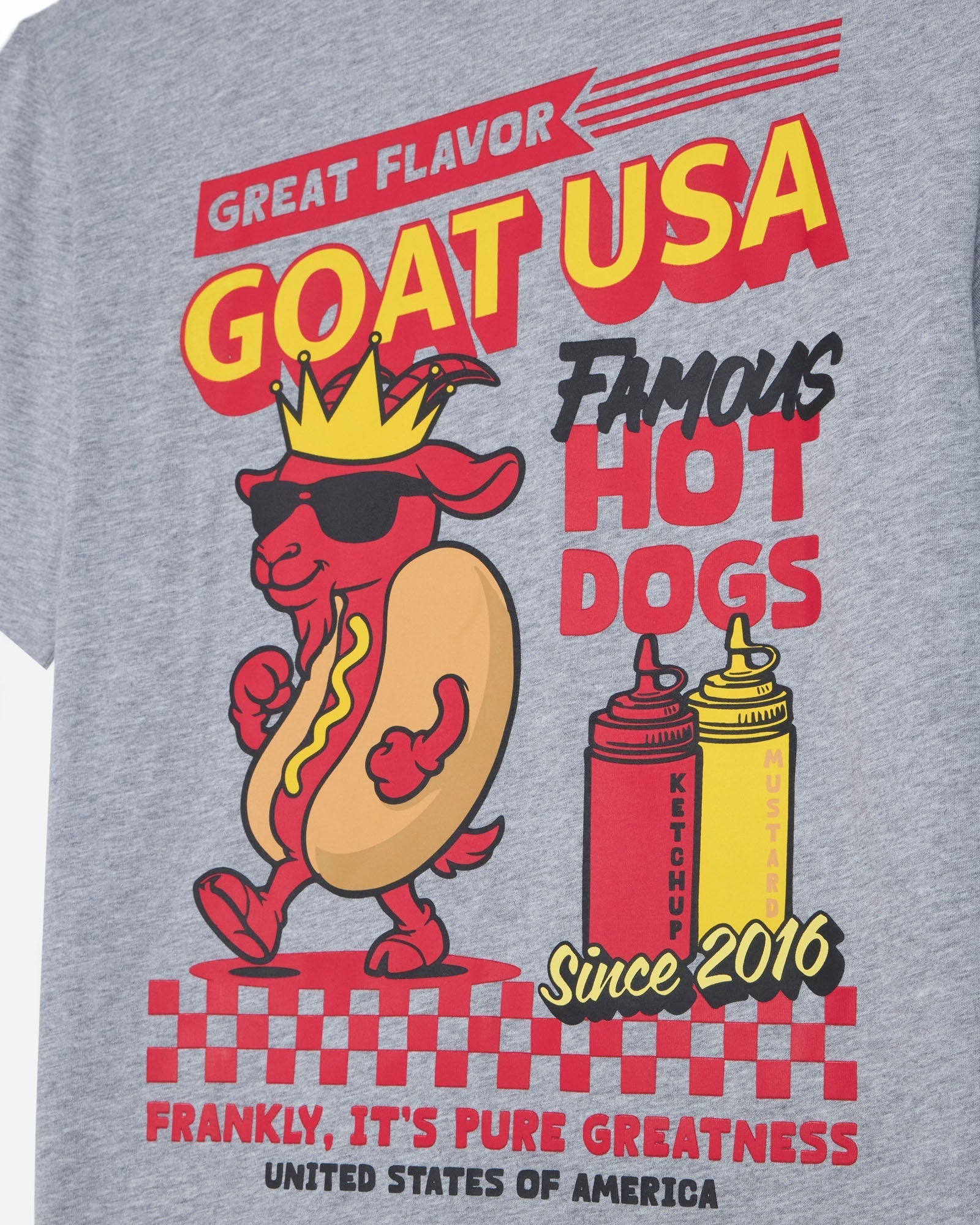 Gray t-shirt with a hot dog graphic and text about 'GOAT USA Famous Hot Dogs' on a gray background.