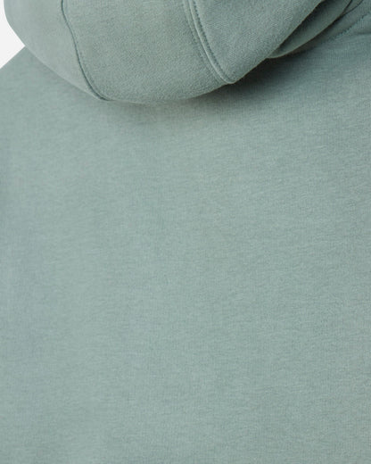 Close-up of a sage green hooded sweatshirt showing the fabric texture and hood seam.