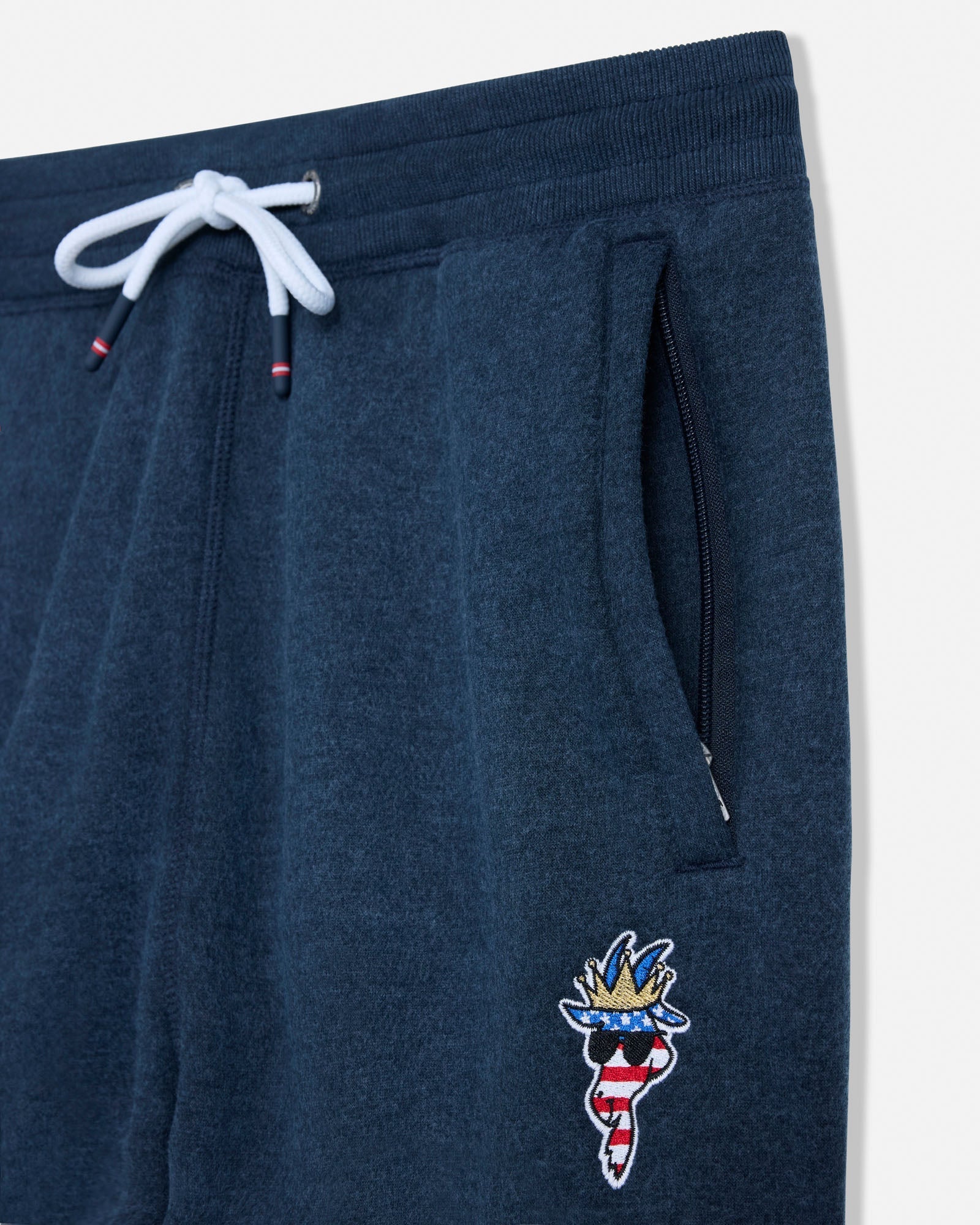 Navy blue sweatpants with a decorative patch on a white background