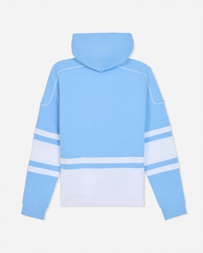A light blue hooded sweatshirt shown from the back, featuring a solid light blue body with a large white block on the lower back and white double stripes on the sleeves.