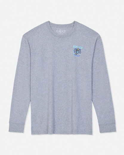 A light heather gray long-sleeve t-shirt with a small light blue and white 'GOAT USA' graphic on the left chest, displayed flat against a light gray background.