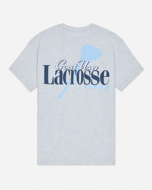 A light heather gray short-sleeve t-shirt with a graphic on the front reading 'Goat USA Lacrosse Club' in navy and light blue, featuring a lacrosse stick design.