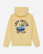 A pale yellow hooded sweatshirt shown from the back, featuring a large graphic print of a sleeping cartoon character on a bed with the text 'LAZY CHILLIN' and 'NAP CLUB' in black.