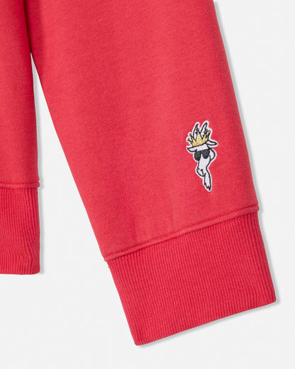 Red sweatshirt with a small embroidered design on a white background#color_poinsettia