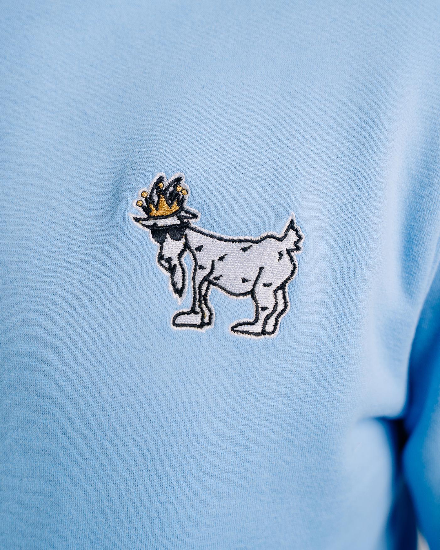 Close-up of logo on carolina blue WG Hooded Sweatshirt#color_carolina-blue
