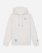 An off-white pullover hoodie with white drawstrings, featuring a small embroidered character on the left chest and a circular patch on the lower left front pocket, shown against a light gray background.#color_bone