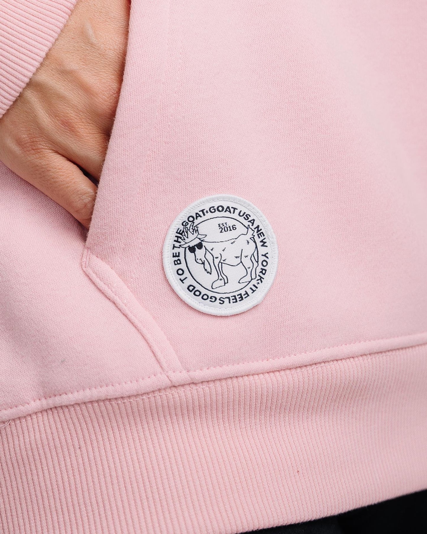 Close-up of patch on pink WG Hooded Sweatshirt#color_pink