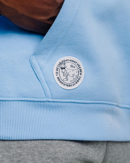 Close-up of patch on carolina blue WG Hooded Sweatshirt#color_carolina-blue