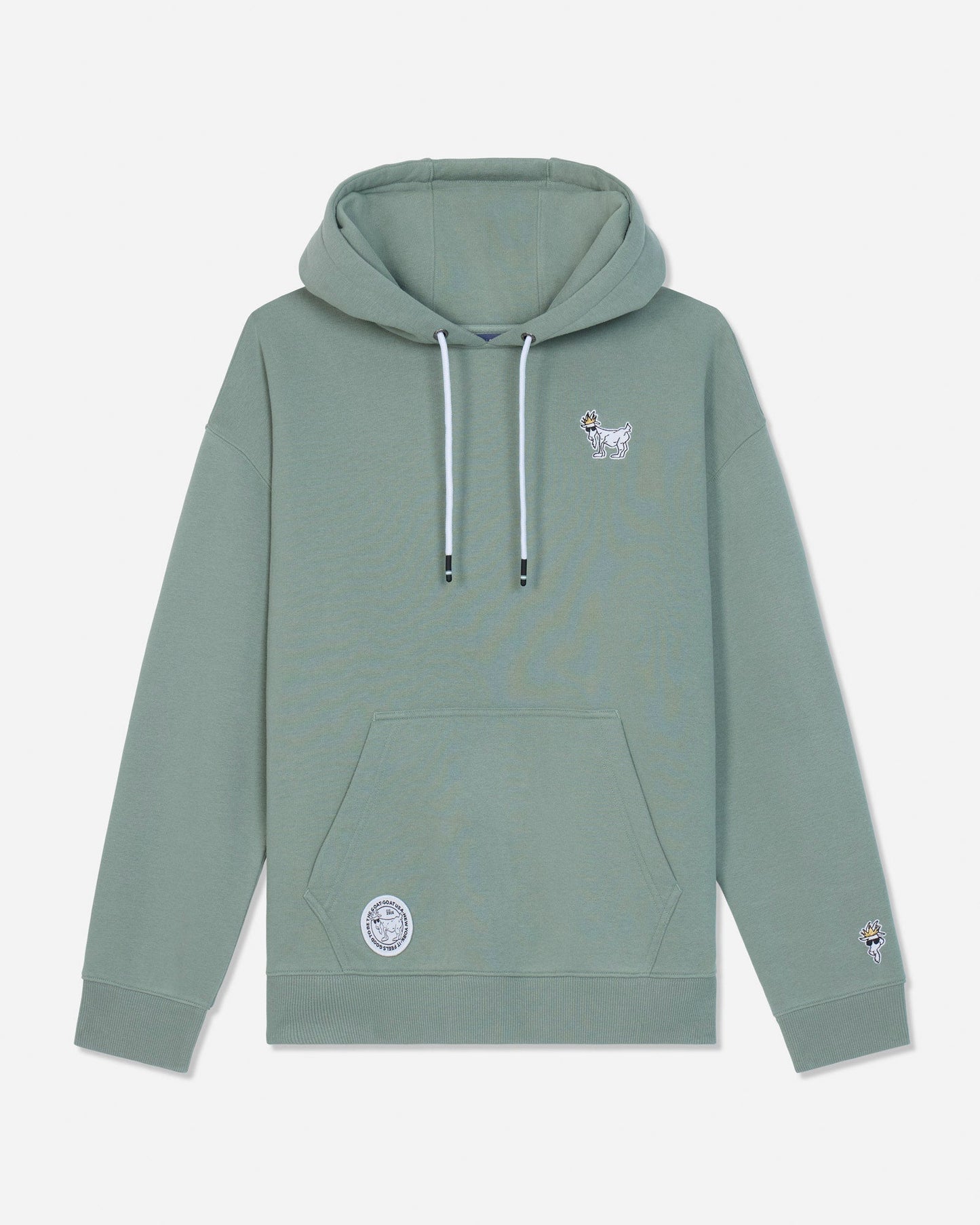A sage green pullover hoodie with white drawstrings, featuring a small white goat graphic on the left chest and a circular patch on the lower left front pocket, displayed against a light gray background.#color_steeped-sage