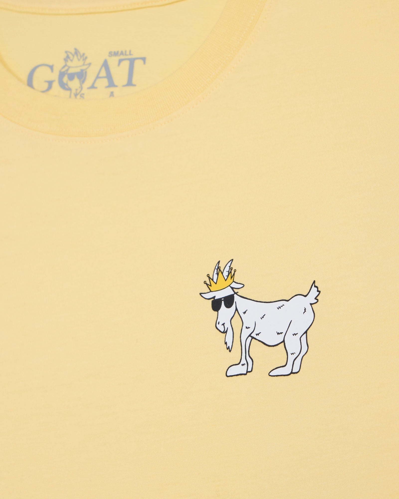 Yellow t-shirt with a cartoon goat wearing a crown and sunglasses on a yellow background.#color_corn-milk