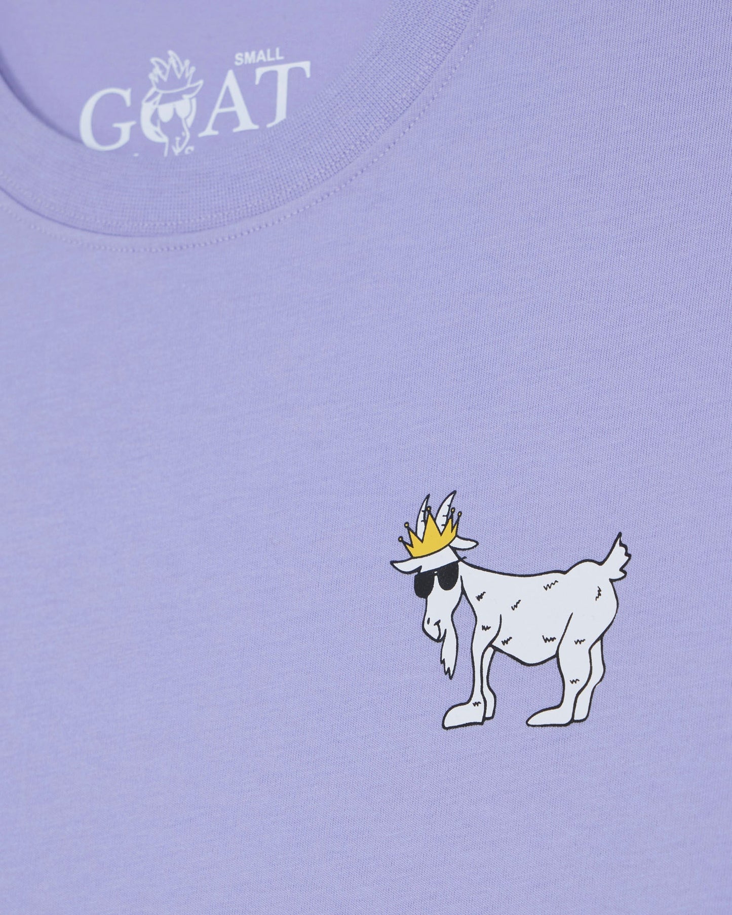 Purple t-shirt with a cartoon goat wearing a crown on a light purple background#color_periwinkle