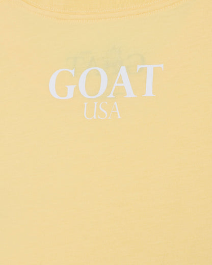 Yellow t-shirt with 'GOAT USA' text on a yellow background#color_corn-milk