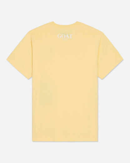 Yellow t-shirt with 'GOAT USA' text on the back against a white background#color_corn-milk