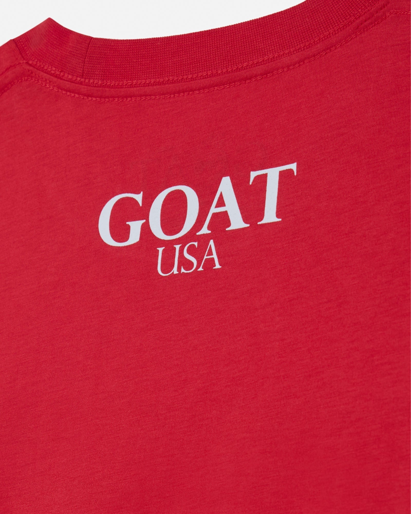 Red shirt with 'GOAT USA' text in white on a white background#color_poinsettia