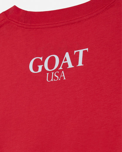 Red shirt with 'GOAT USA' text in white on a white background#color_poinsettia