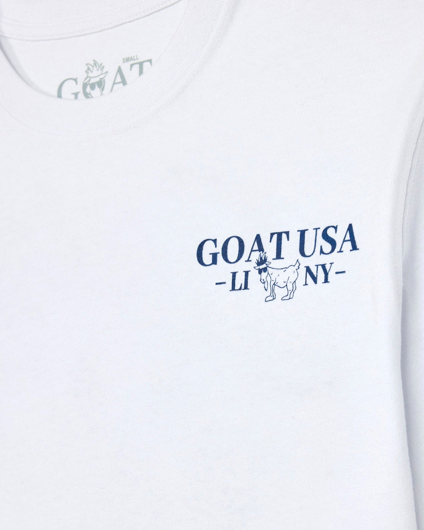 White t-shirt with blue 'GOAT USA' logo on a white background