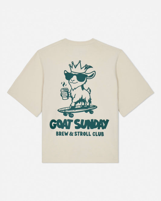 Beige t-shirt with a graphic of a goat on a skateboard and text 'GOAT SUNDAY Brew & Stroll Club' on a white background