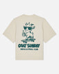 Beige t-shirt with a graphic of a goat on a skateboard and text 'GOAT SUNDAY Brew & Stroll Club' on a white background