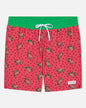 Red swim shorts with green watermelon pattern on a white background