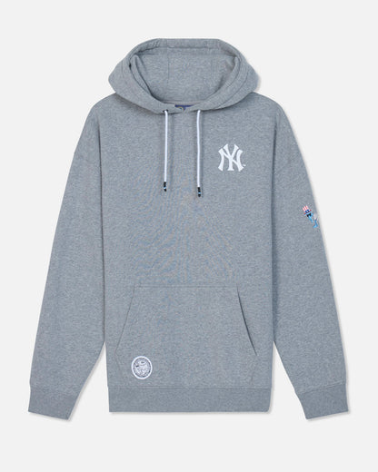 A heather gray pullover hoodie featuring a white New York Yankees logo on the left chest, a white circular patch on the lower left front, and a small colorful patch on the right sleeve, displayed against a light gray background.