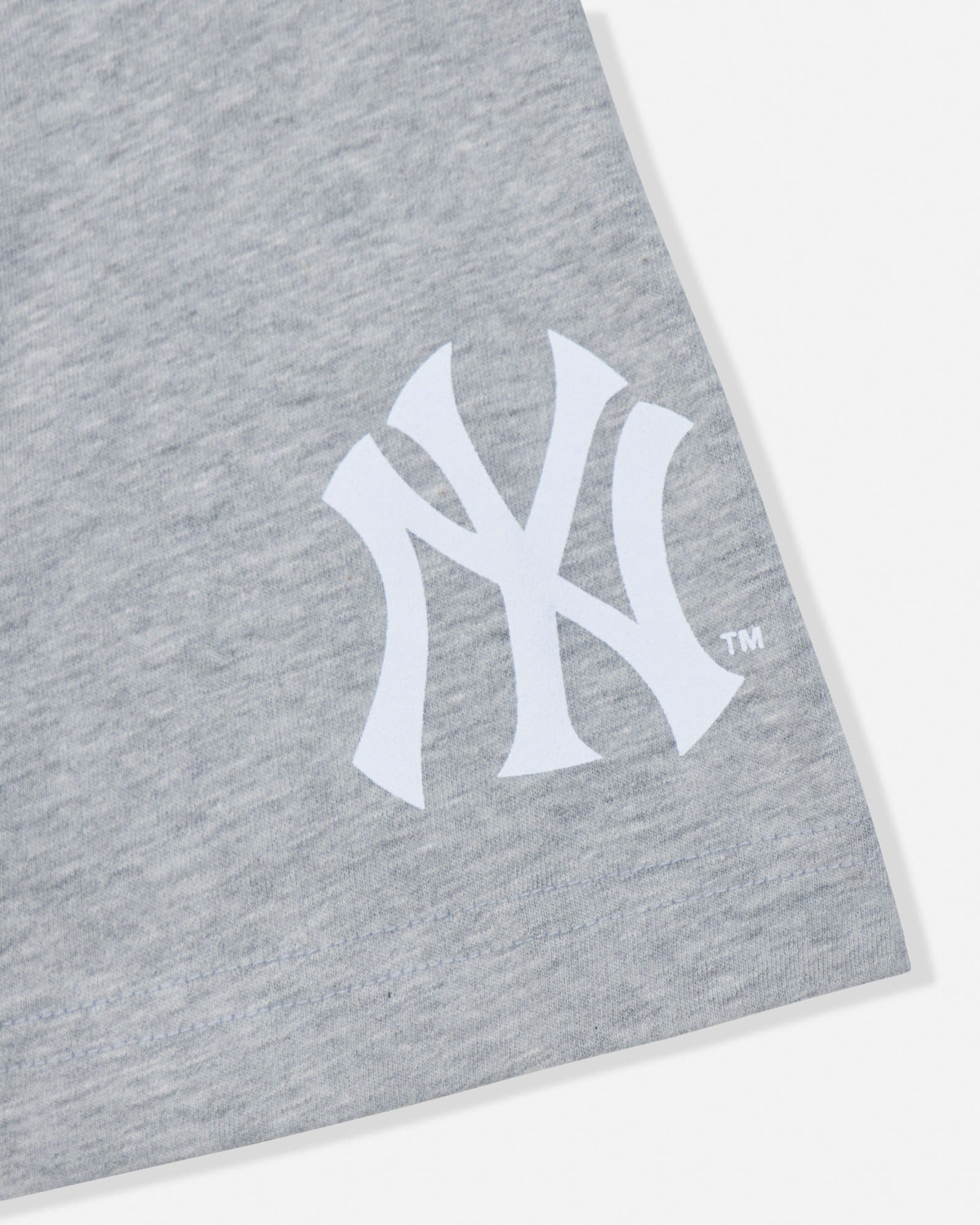 Close-up of a heather gray fabric product featuring a large white New York Yankees interlocking NY logo on the front.