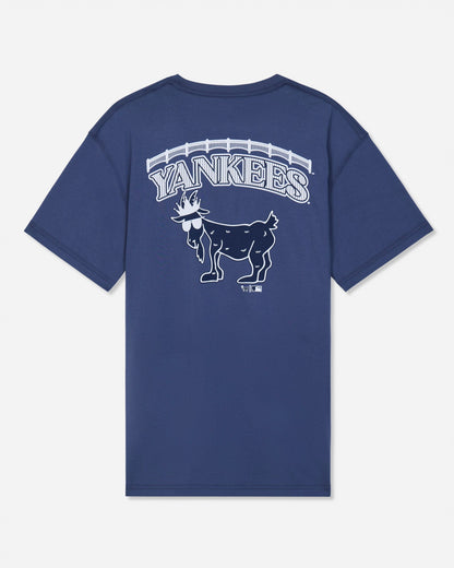 A navy blue short-sleeve t-shirt with a white graphic on the back featuring the word 'YANKEES' in an arched font above a detailed goat mascot illustration, set against a light gray background.#color_navy
