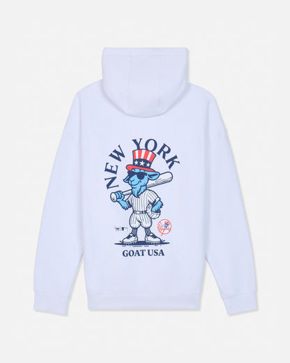 White pullover hoodie shown from the back, featuring a large graphic print of a cartoon blue goat in a baseball uniform with a red, white, and blue top hat, surrounded by the text 'NEW YORK GOAT USA'.#color_white