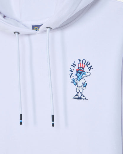 Close-up of a white pullover hoodie with white drawstrings and a blue, red, and white New York City graphic on the chest.#color_white