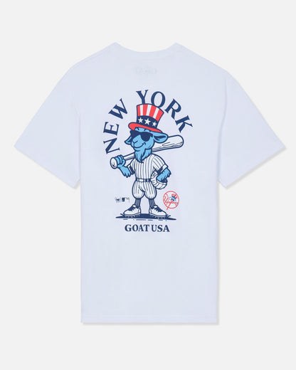 White short-sleeve t-shirt with a large graphic on the front featuring a blue cartoon goat in a baseball uniform, a red and white top hat, and the text 'NEW YORK' and 'GOAT USA'.#color_white